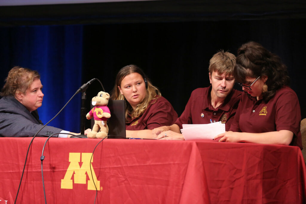 A close up ofUniversity of Minnesota players writing their answers.